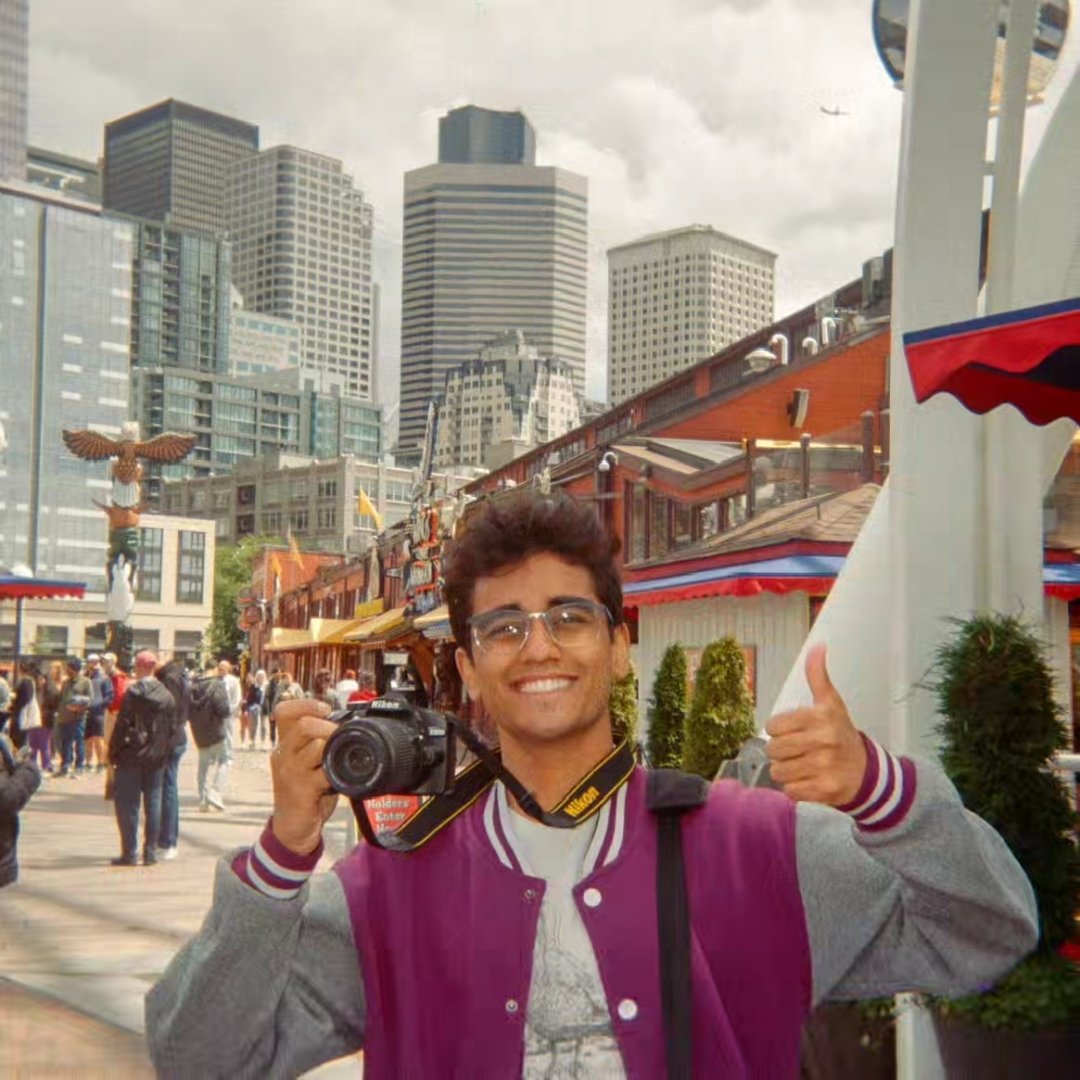 Ayon Wickramasinghe working as a videographer with a camera